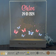 a glass plaque with a picture of butterflies on it