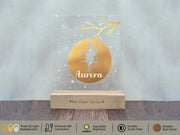 a clear acrylic plaque with a gold silhouette of a couple sitting on a