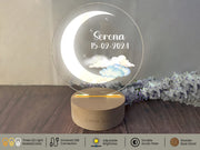 a clear glass plaque with a moon and clouds on it