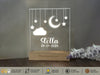 a personalized acrylic night light on a wooden stand