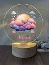 a personalized acrylic lamp with a picture of a full moon and clouds