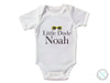 a white bodysuit with the words little dude noah on it