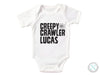 a white bodysuit that says creepy crawler lucas