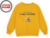 a yellow sweatshirt with a cake on it