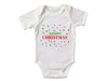 a white bodysuit with merry christmas written on it