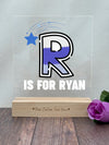 a wooden block with a picture of a r is for ryan