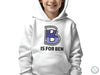 a young boy wearing a white hoodie with the letter b is for ben on