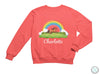 a pink sweatshirt with a horse and rainbow in the background