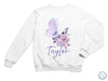 a white sweatshirt with a butterfly and flowers on it