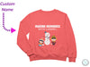 a pink sweatshirt with a picture of a snowman and two children