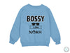 a blue sweatshirt that says bossy like noah