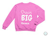 a pink sweatshirt that says, dream big grace