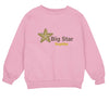 a pink sweatshirt with a big star on it